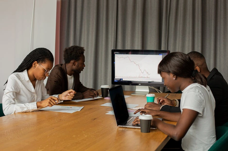 Diverse team of analysts looking at holographic data screens